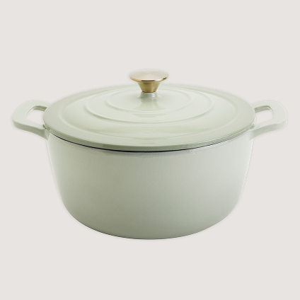 Light green cookwear with a silver handle on top.