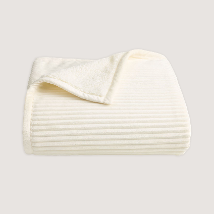 Cream colored blanket folded into a square.