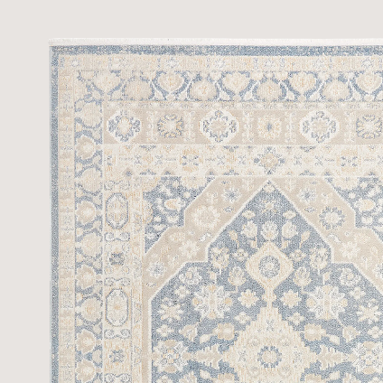 Gray rug with blue patterns throughout.