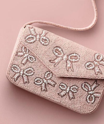 Pink handbag with pink ribbon designs covering it.