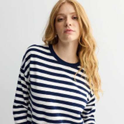 Model wearing a black and white striped top.