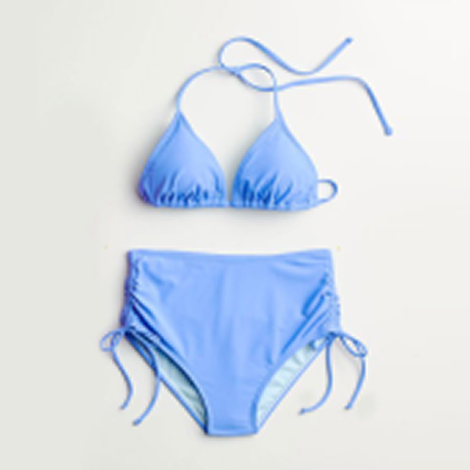 Light blue bikini laid out over a gray background.