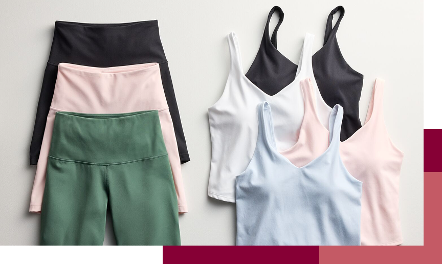 Assortment of athletic leggings, shorts, sports bras, and tank tops in black, pink, green, white, and light blue.