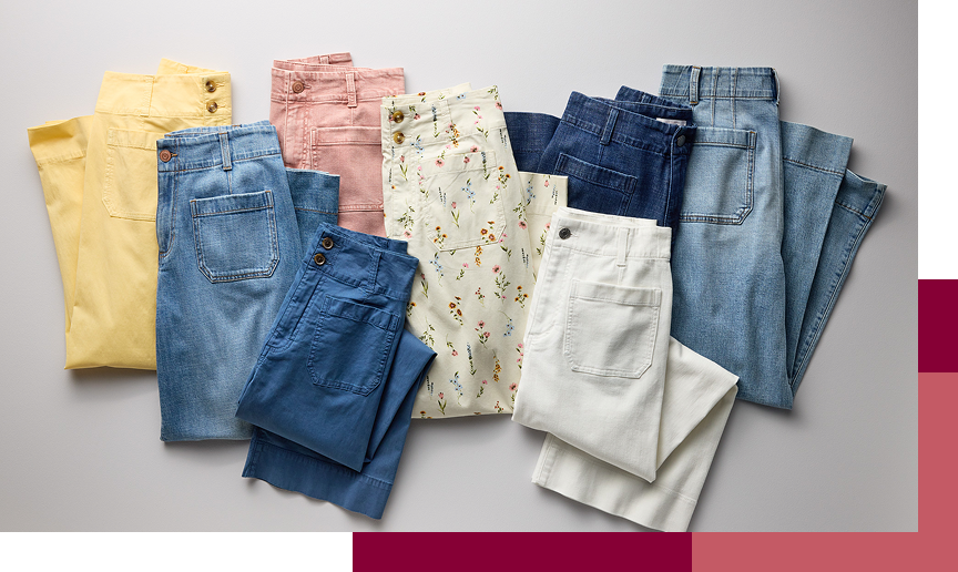 Assortment of folded women’s jeans, pants, shorts, and skirts in denim, white, yellow, and floral prints.