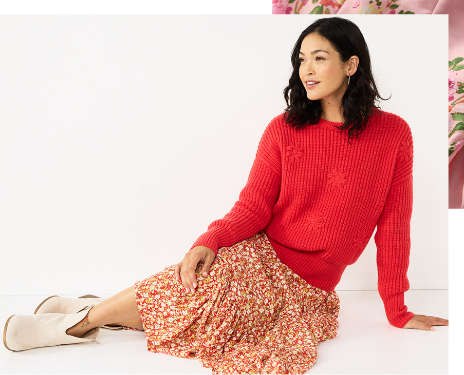 Woman wearing a red sweater and floral skirt