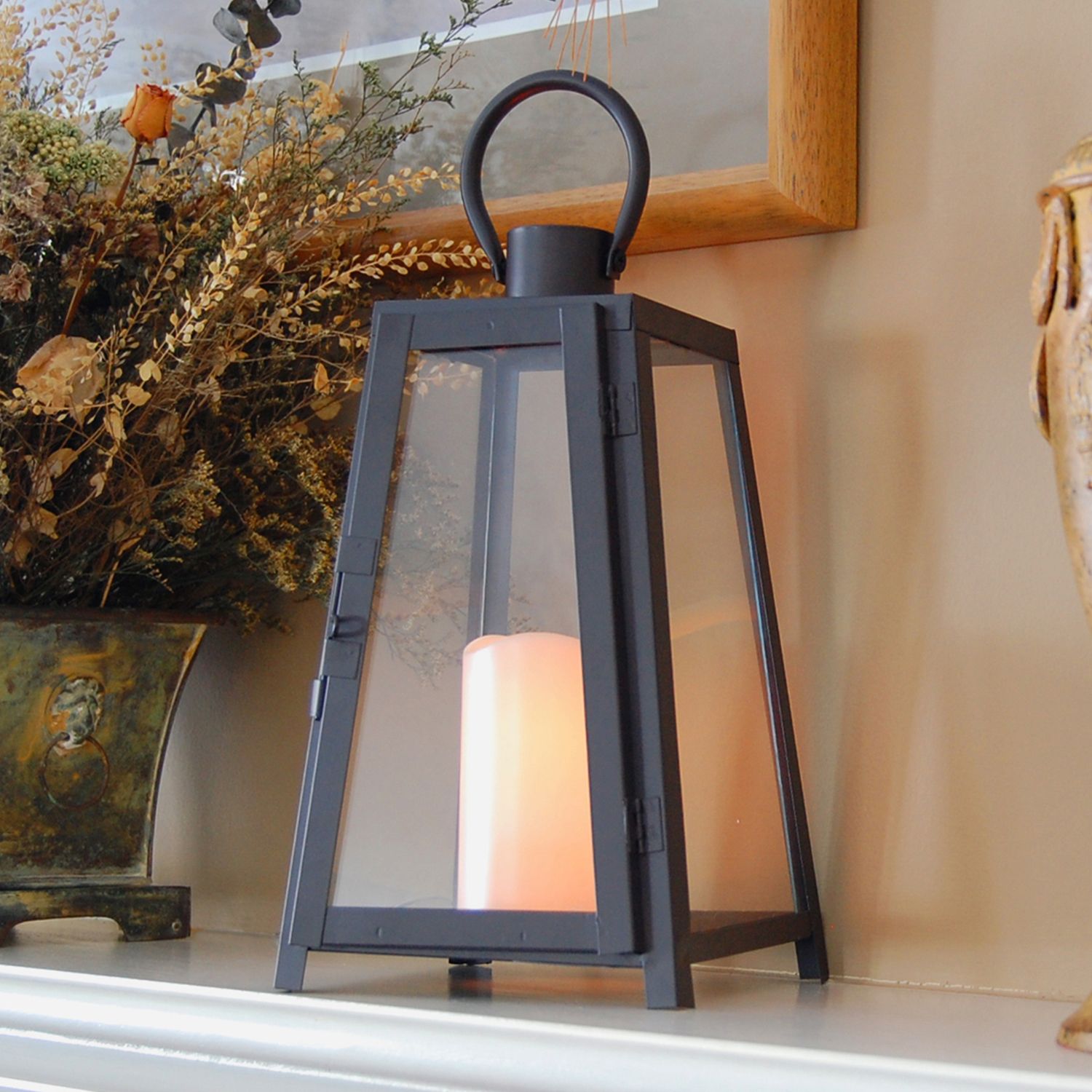 A stunning lantern or candle can elevate the look of a shelf or fireplace mantle.