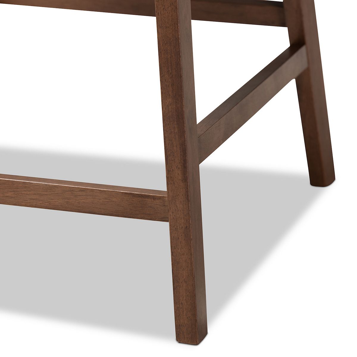 Walnut leg and cross-brace detail on Larine counter stool