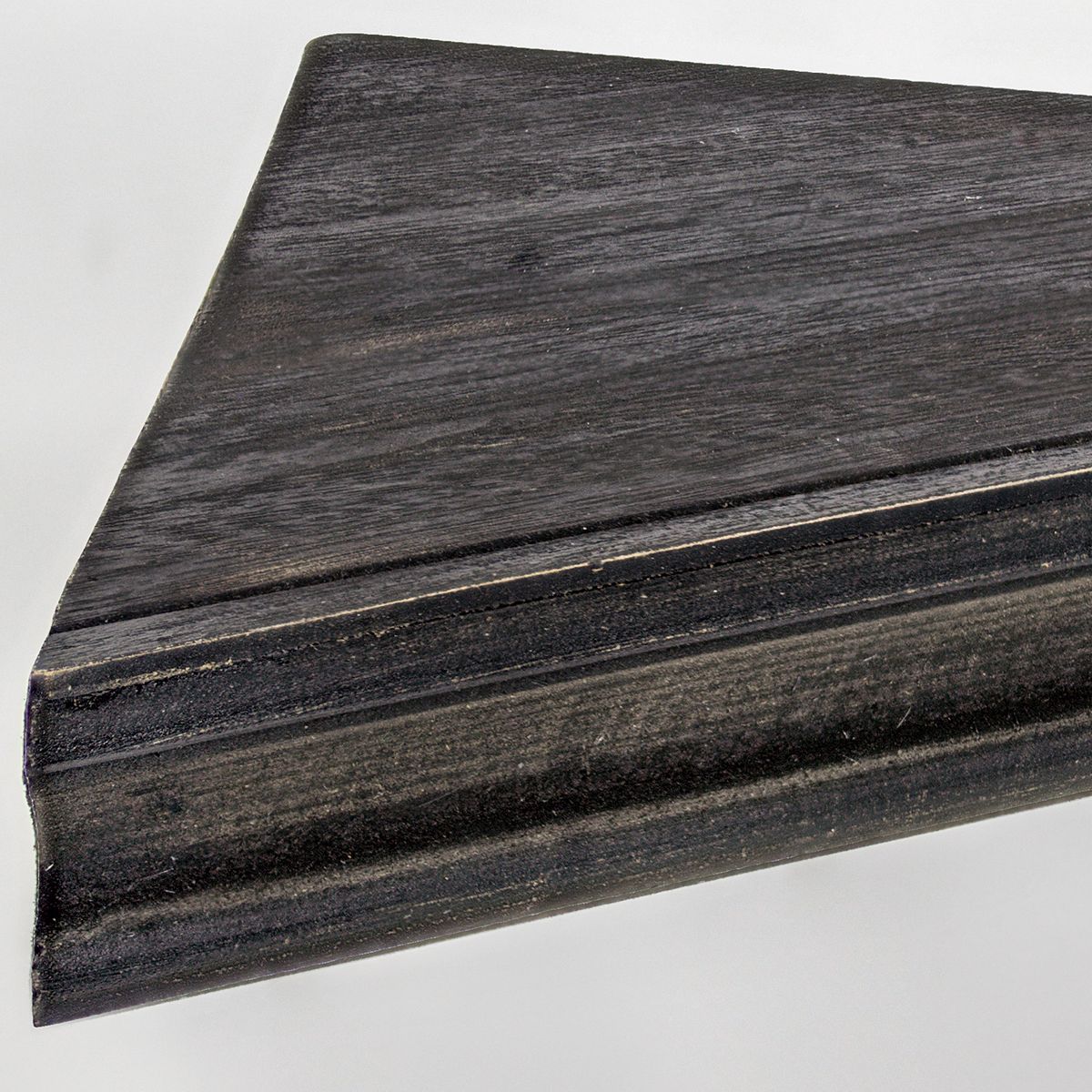 Close-up of dark rustic wood finish on floating indented corner shelf