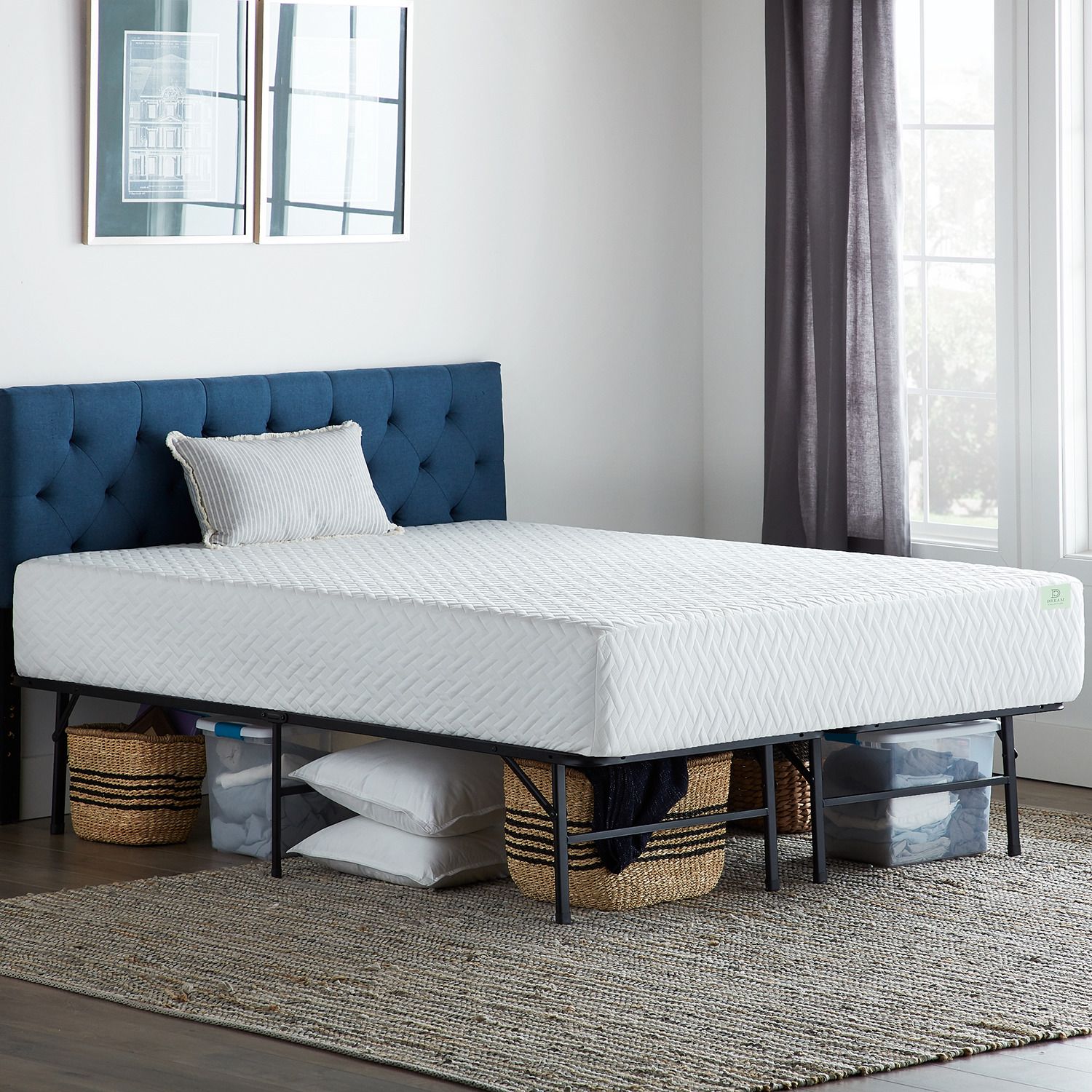 White plush memory foam mattress on black platform bed frame with tufted blue headboard