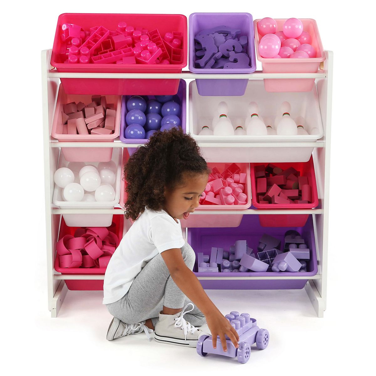 Child playing with toy organizer and colorful storage bins