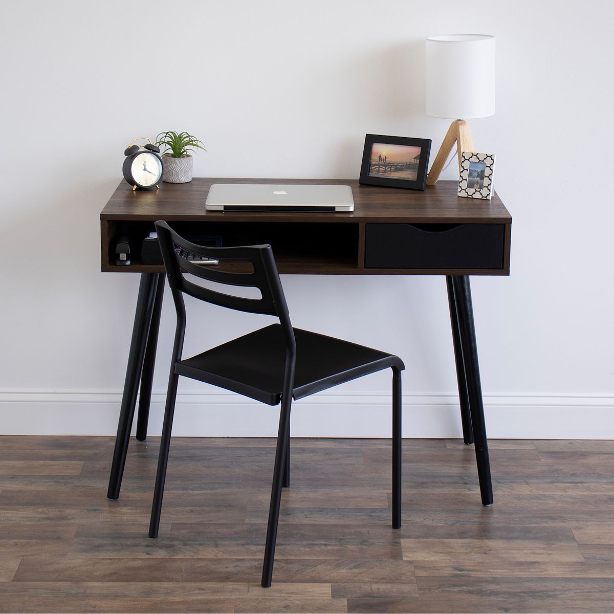 Black industrial desk chair with open metal back and cushioned seat
