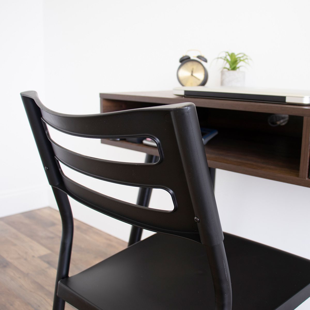 Close-up of black industrial desk chair backrest and arm supports