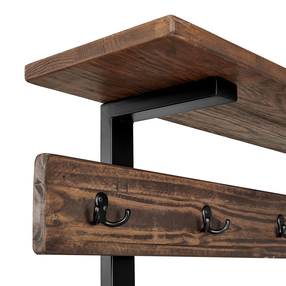 Close-up of coat hooks on distressed wood rail