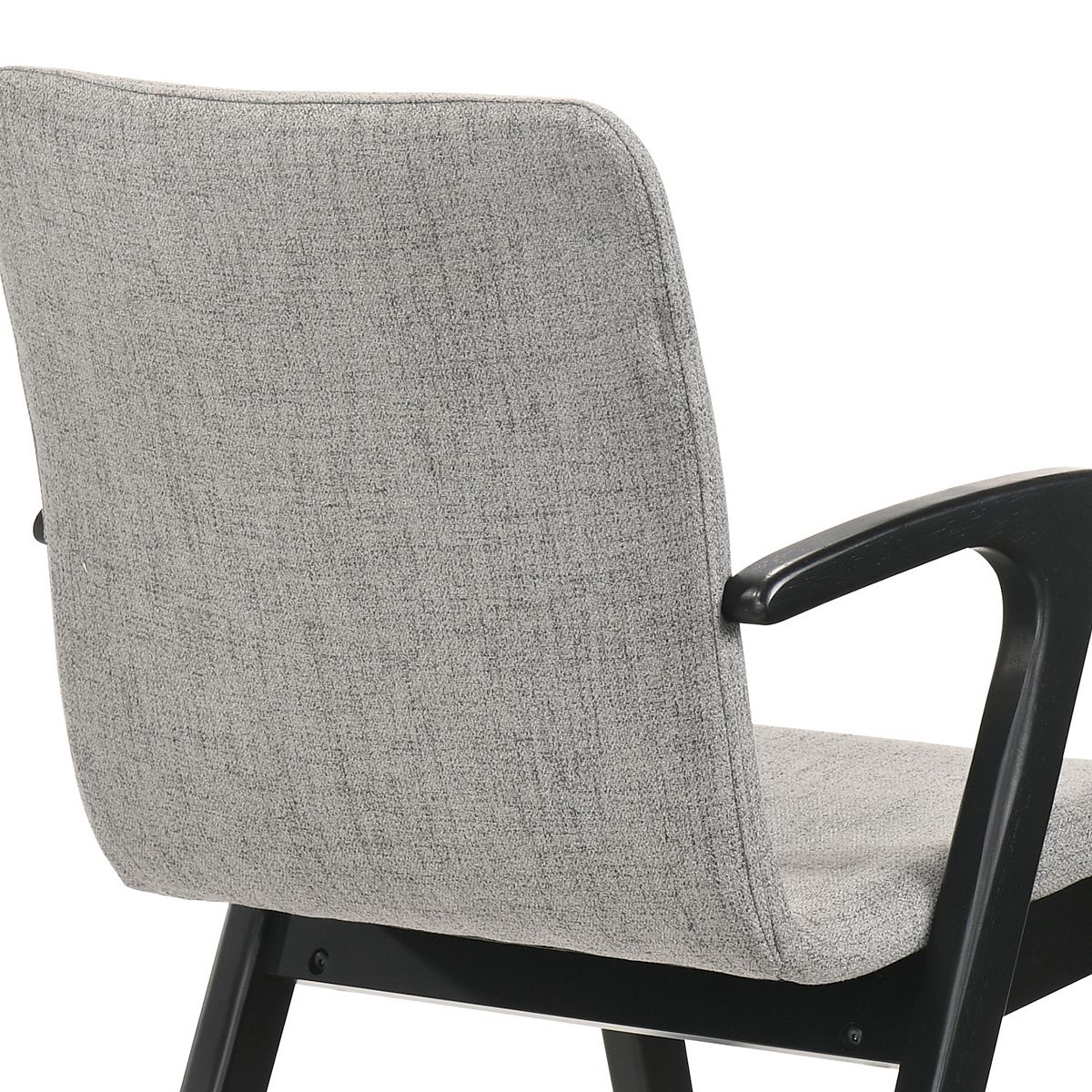 Close-up of grey upholstered dining chair arm and black frame