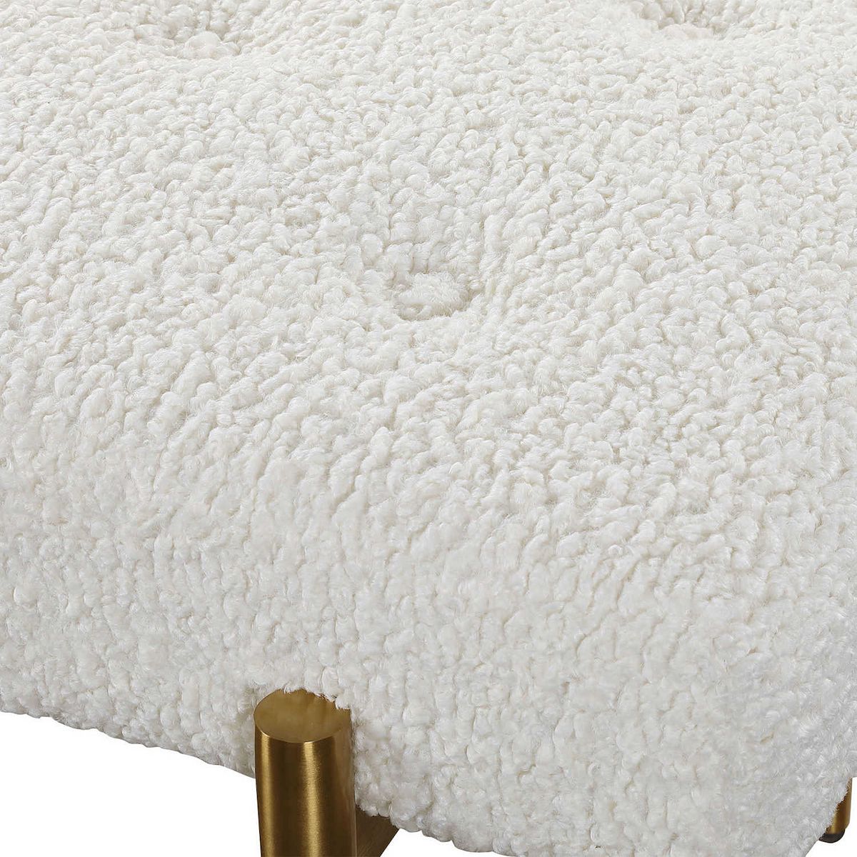 Close-up of cream boucle upholstery on Olivier Bench and gold leg