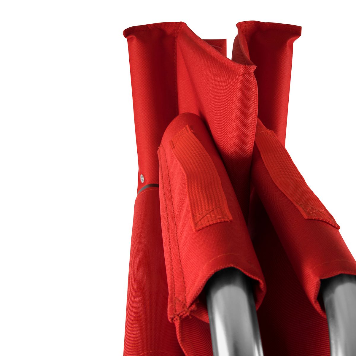 Close-up of cardinal red fabric panels on portable folding sports chair.