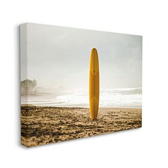 Stupell Home Decor Yellow Surfboard in Sand Near Shore Photograph Canvas Print Wall Art