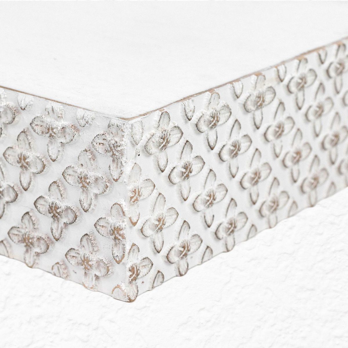 Close-up of embossed geometric pattern on floating wall shelf