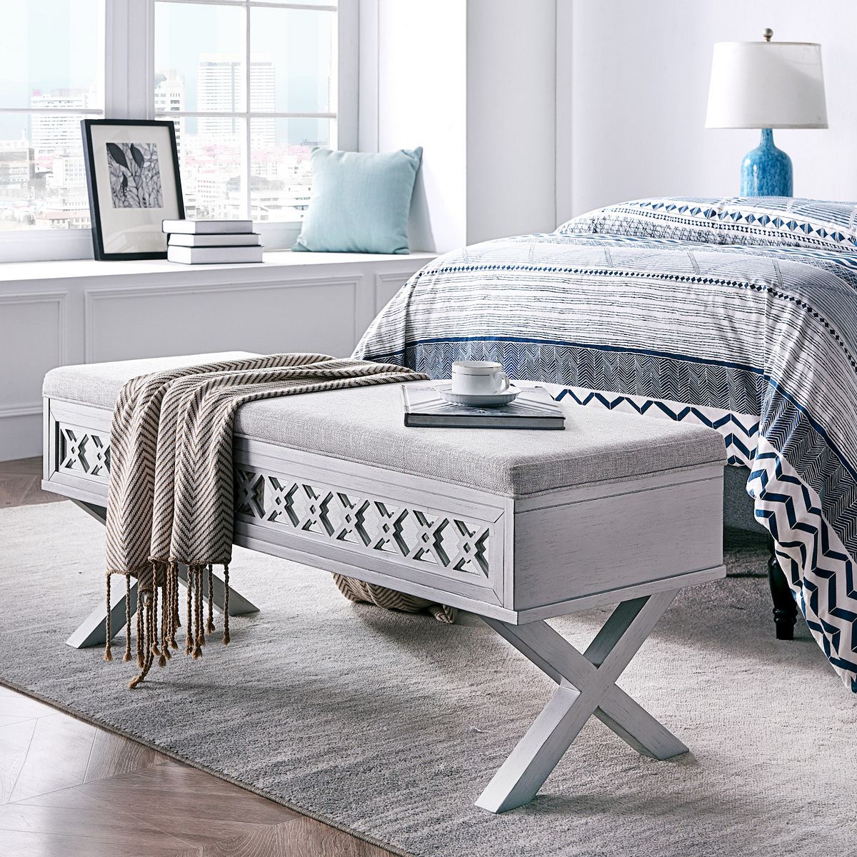 Mirror diamond cutout storage bench with upholstered top and open X legs in bedroom