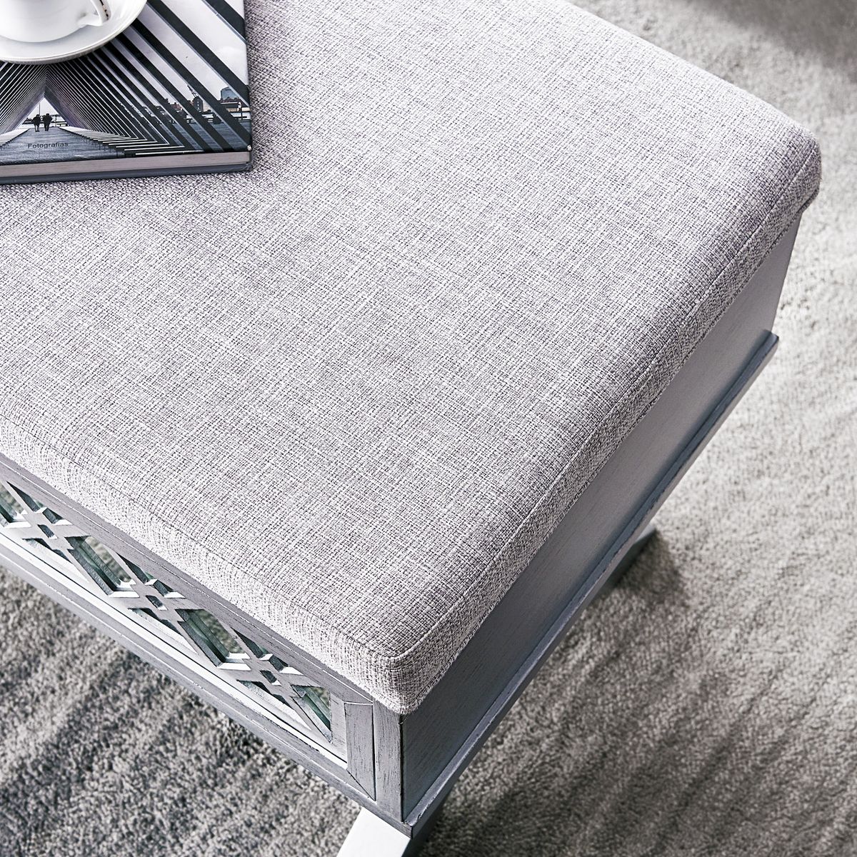 Close side view of light gray storage bench frame and diamond cutout detail