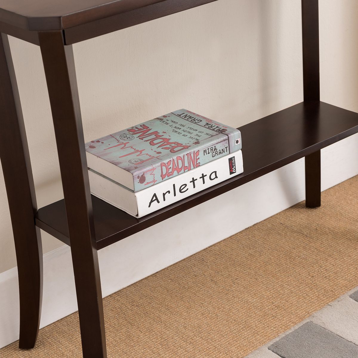 Console hall stand lower shelf close-up in dark brown.