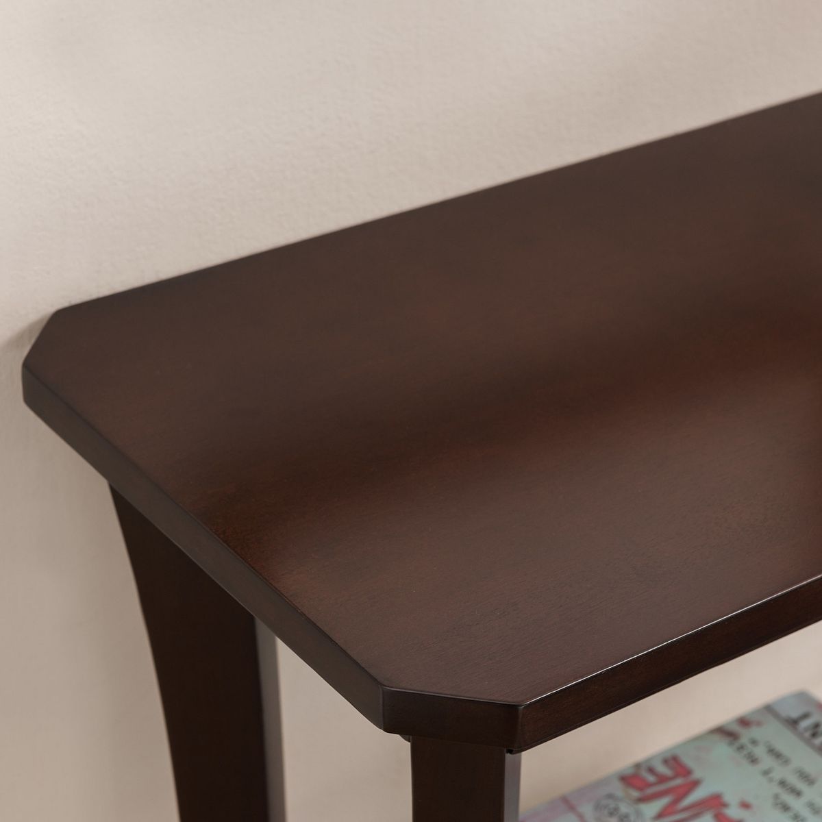 Close-up of console hall stand tabletop edge in dark brown.