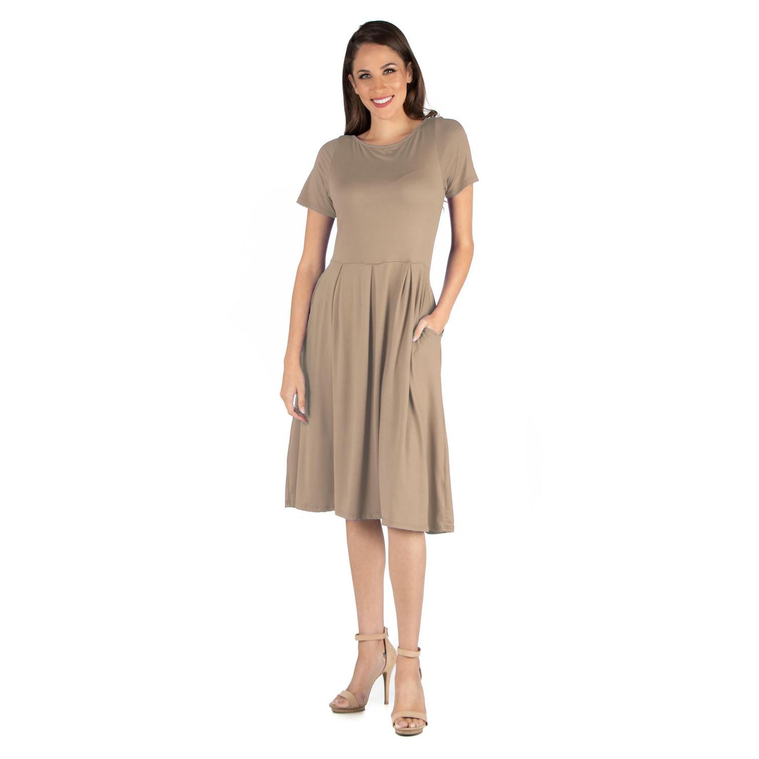 a woman wearing a taupe dress