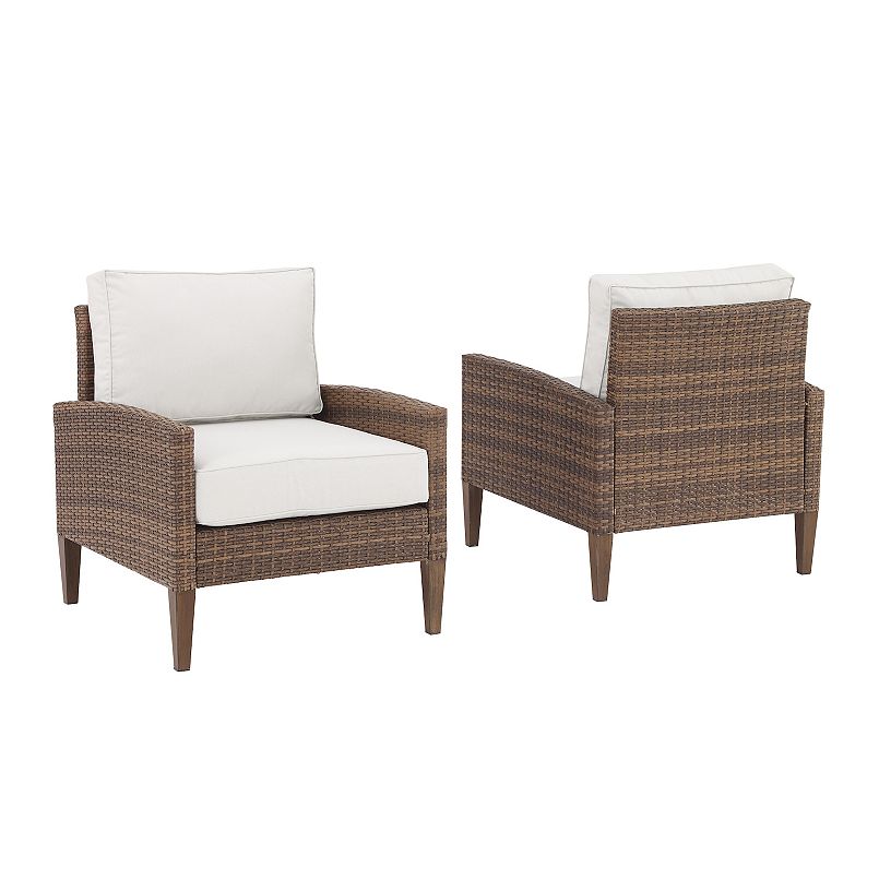 Two-piece outdoor wicker chair set with white cushions in brown wicker.