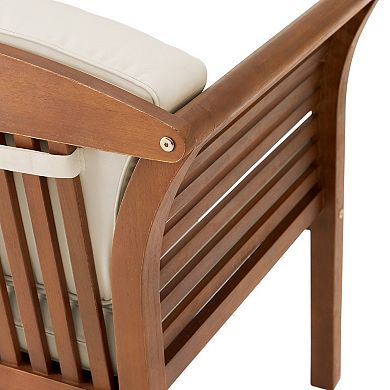 Close-up of chair armrest connection and brown slat back