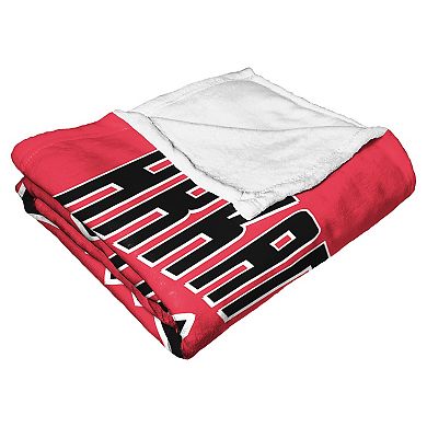 The Northwest Arkansas State Red Wolves Alumni Silk-Touch Throw Blanket