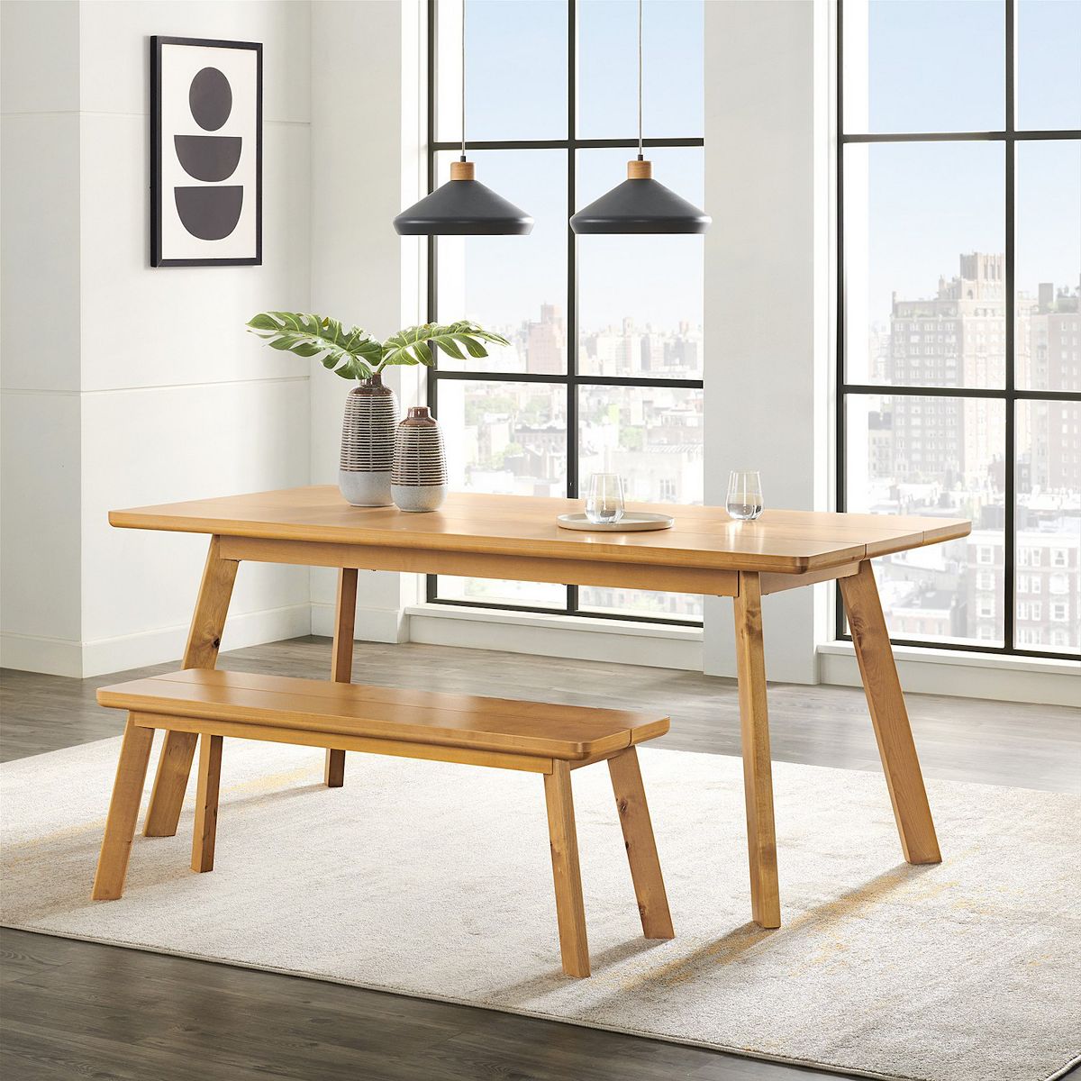 Dining table with bench set in modern dining room near windows