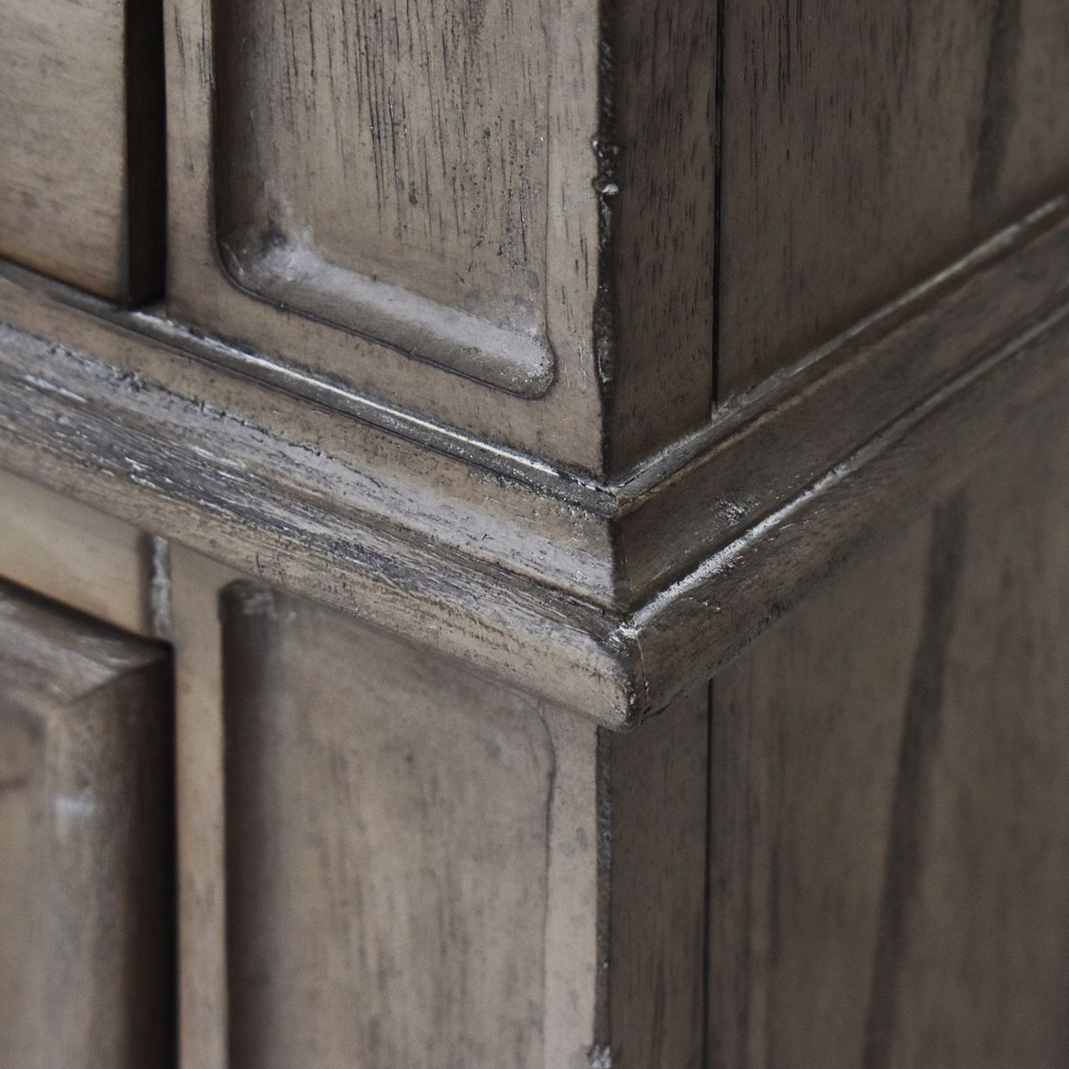 Close-up of nightstand corner molding and cabinet trim