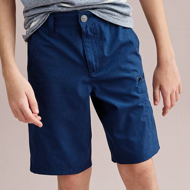 A boy wearing blue shorts