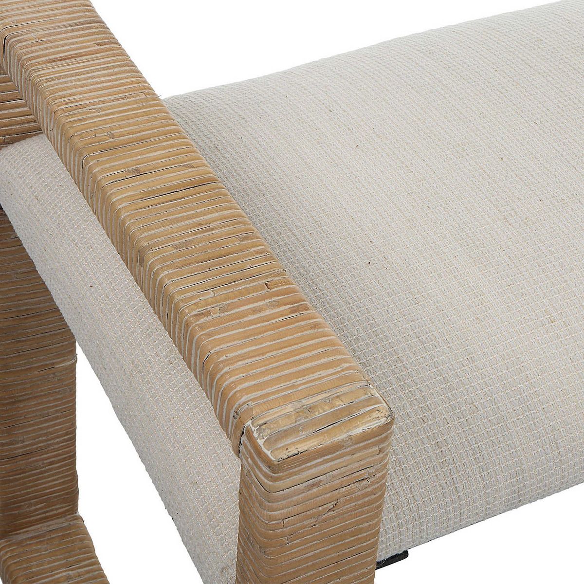 Close-up of woven tan frame and light cream cushion on Uttermost Areca bench