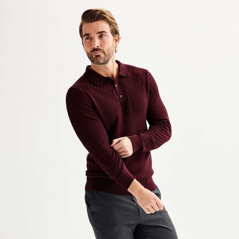 A man in a burgundy sweater polo