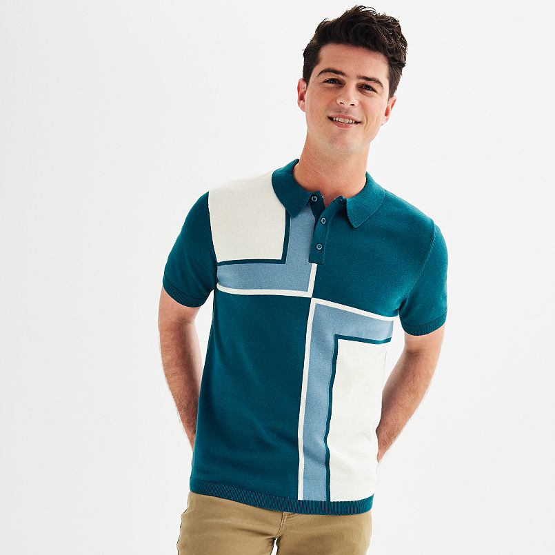 A man wearing a blue and white color blocked sweater polo shirt