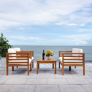 Outdoor wooden patio furniture with two chairs on each side of a table by the ocean