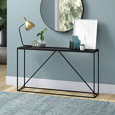Console table with decorative items against blue wall