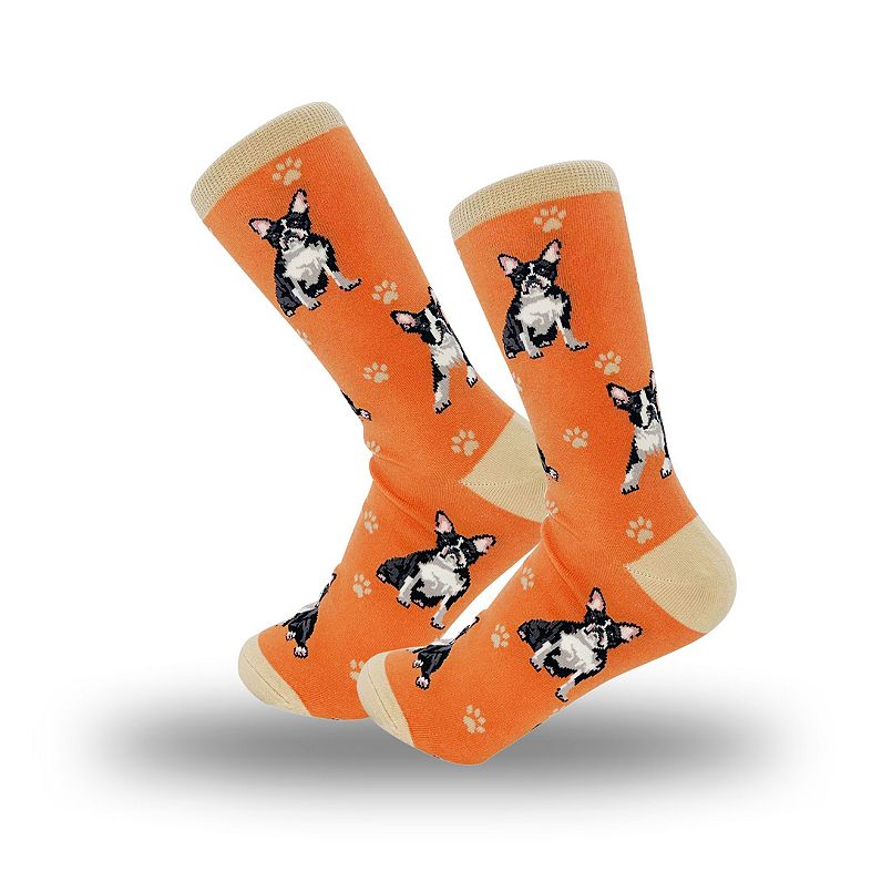 A pair of orange socks with black and white Boston Terriers on them