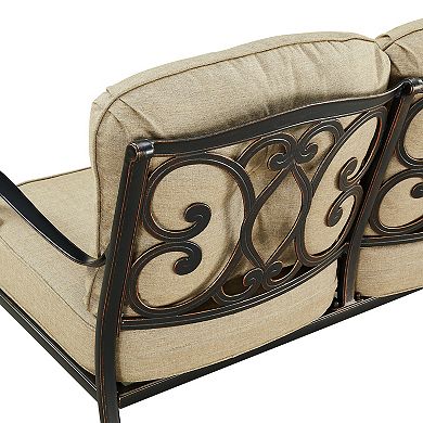 Decorative back of loveseat showing ornate metalwork