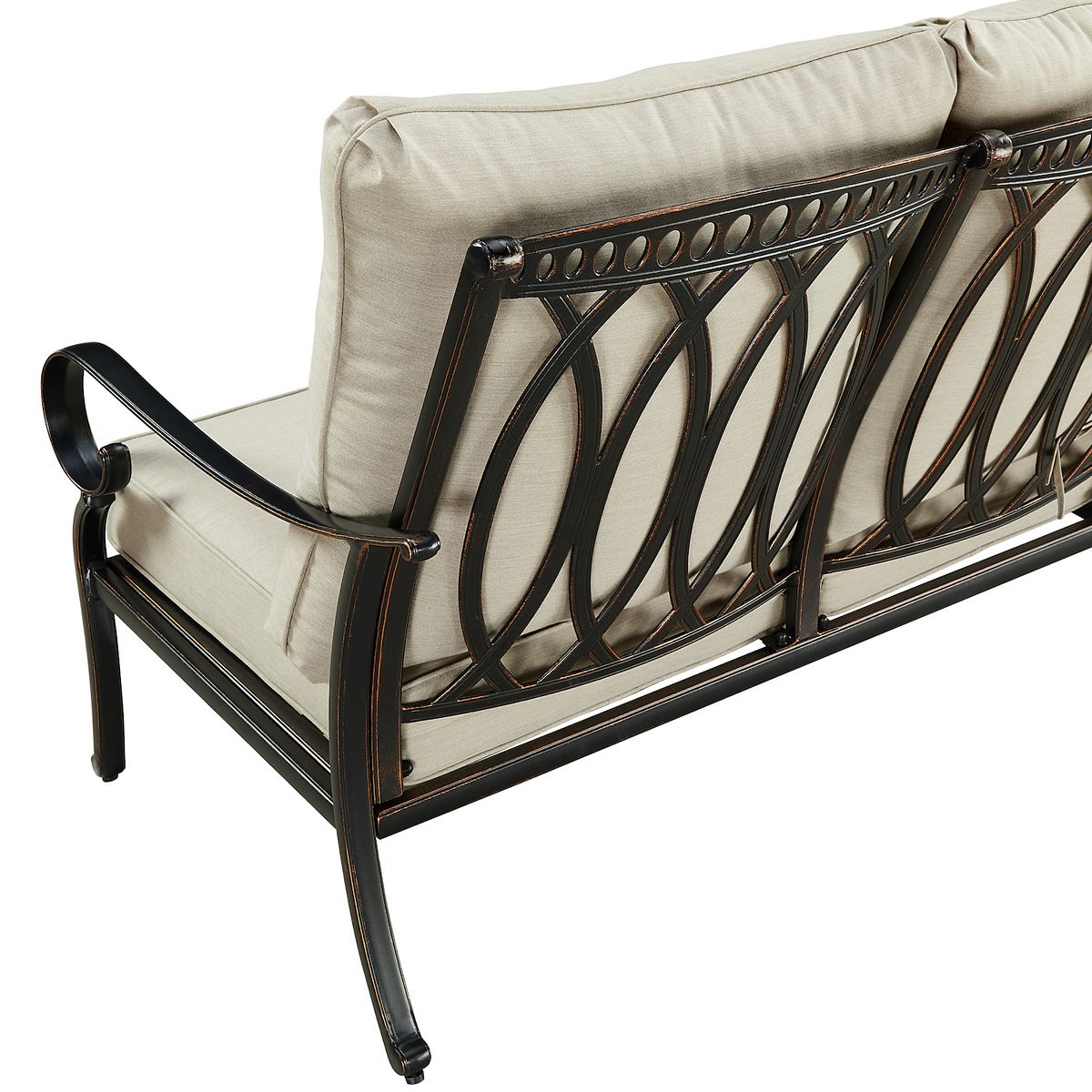Loveseat back frame detail with decorative metalwork in dark bronze