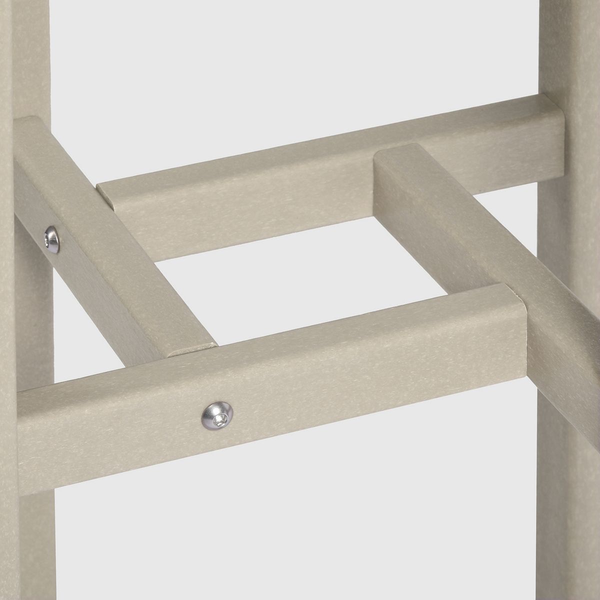 Close-up of metal bracket and frame joint on bar bistro set