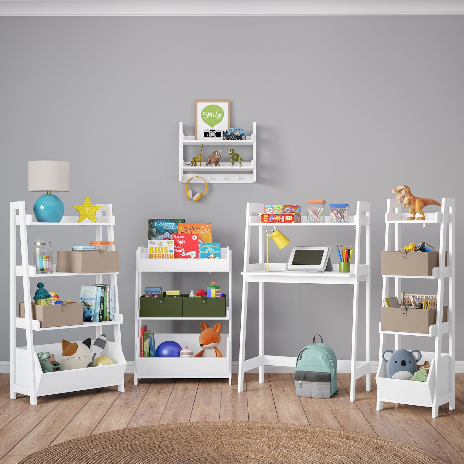 Group of white ladder shelves and desk with toy storage in a kids’ room