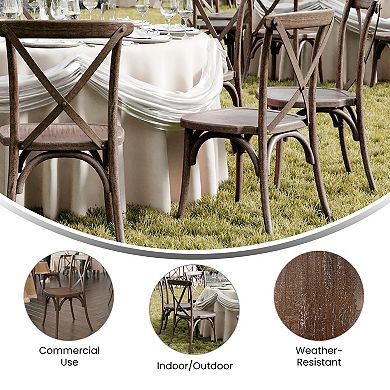 Cross-back chairs around an outdoor round table set on grass