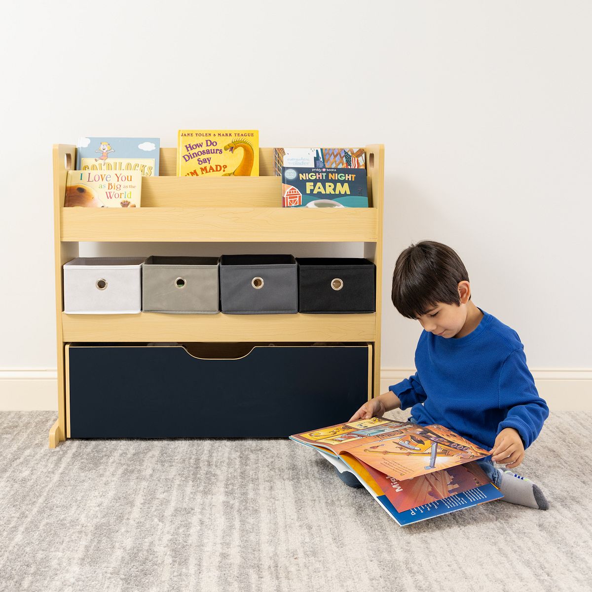 Child using Humble Crew storage cabinet with bins and dark drawer front