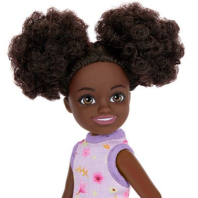 Barbie Chelsea Doll, Small Doll Wearing Removable Purple Floral Dress with Space Buns & Brown Eyes by Mattel