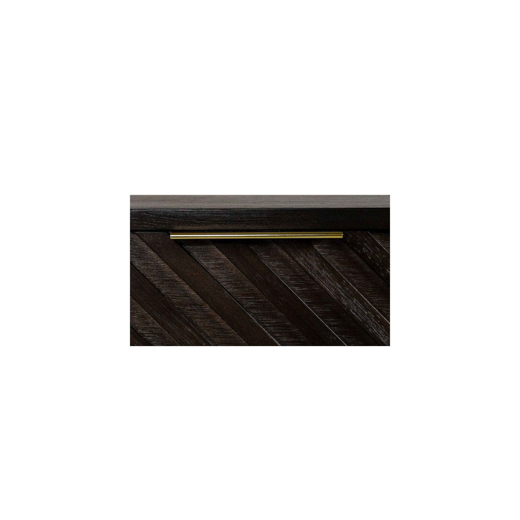 Close-up of brass handle on chevron veneer drawer