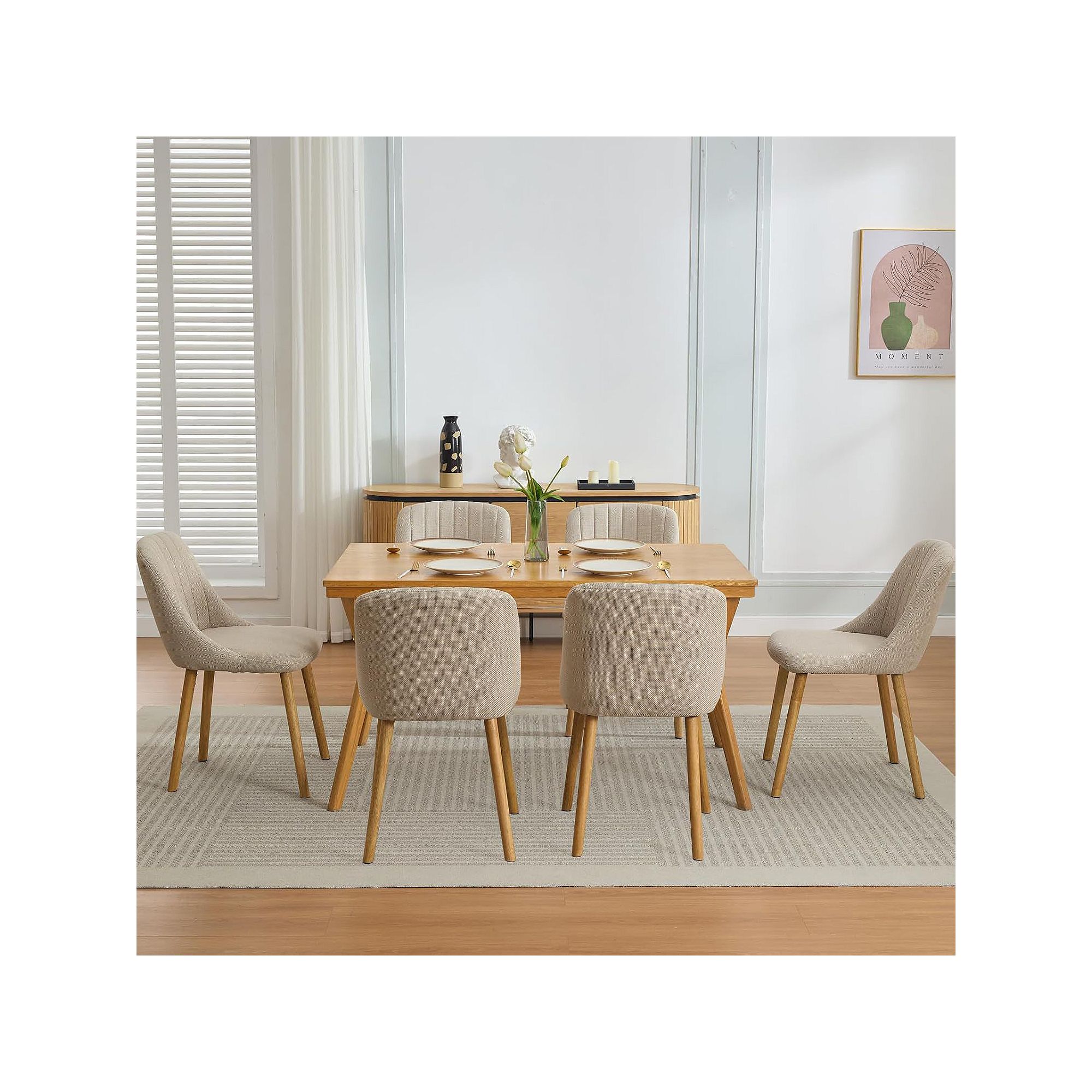 Set of upholstered dining chairs with oak legs around a dining table.