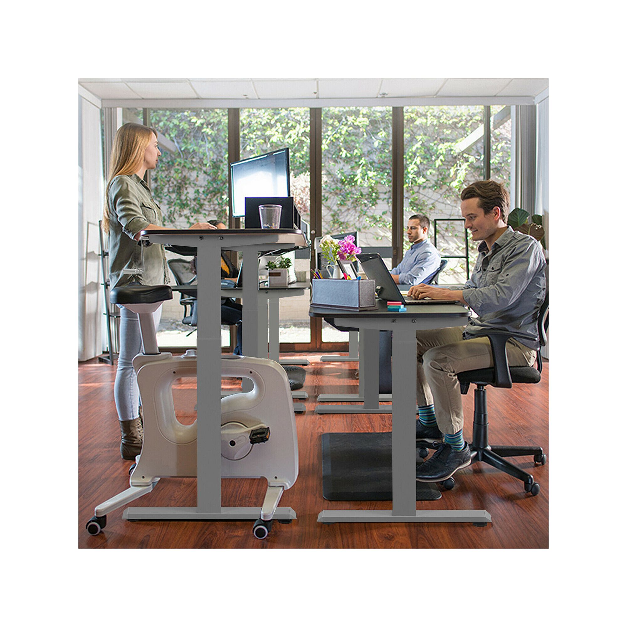 Grey sit-to-stand desk frame used for standing at a workstation