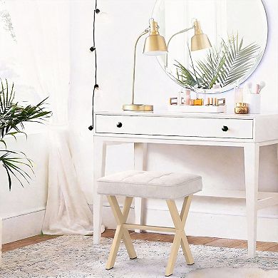 A compact stool with a padded seat and a metal X-shaped base; a vanity stool.